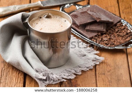 Freshly cooked hot chocolate with foam in a tin mug