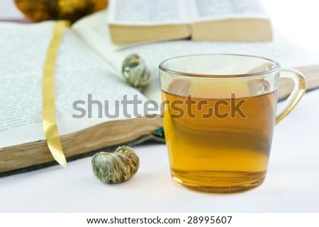 Green tea in the glass and the opened books