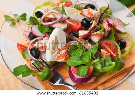 Salad with fish, eggs, tomatoes cherry and olives
