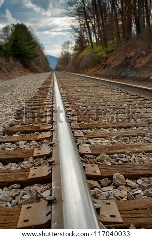 Close up image of railroad from a low perspective seeing the rail and the distance on the track in North Carolina