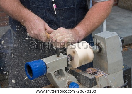 close up of worker turning wood on a lathe