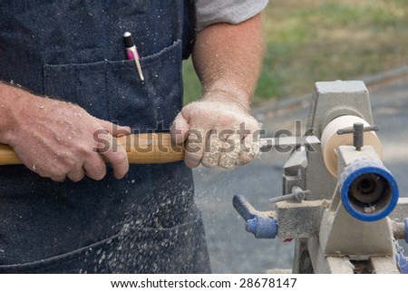 close up of worker turning wood on a lathe