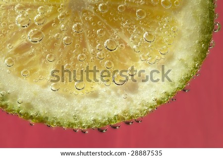 Lime being dropped in carbonated water