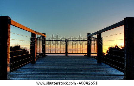 Wooden deck on coastline of Great Ocean Road, Australia during sunset