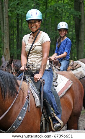 mother and daughter  horseback riding
