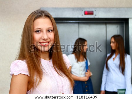 Three young women near the elevator