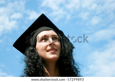 Happy graduate student against blue sky