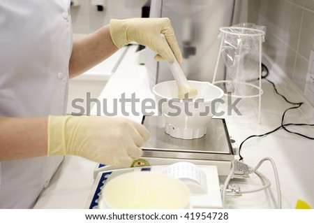 preparation of a medicine in a laboratory with mortar, pestle and electronic balance