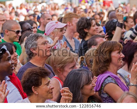 BRISTOL, ENGLAND - JULY 30: Diverse audience cheering an act in the Dance Village at the Harbour Festival in Bristol, England on July 30, 2011