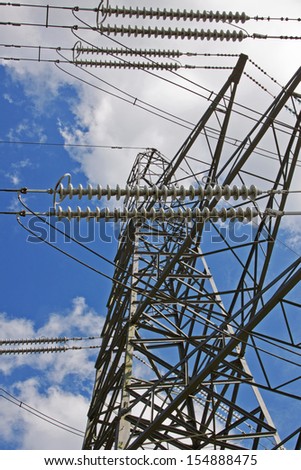 High voltage power cables supported by a pylon in the English countryside