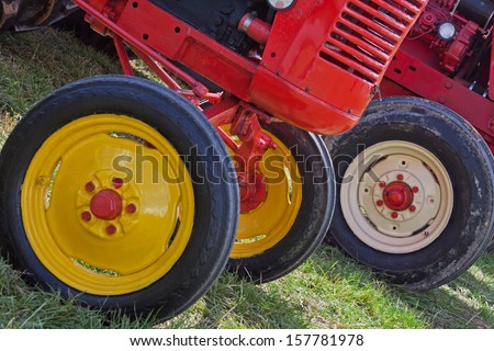 Colourful wheels on restored vintage tractors at an agricultural fair UK