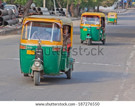 DELHI, INDIA - MARCH 17, 2014: Auto rickshaws, known as Tuk Tuks, dominate roads around the Indian capital , providing a cheap taxi service for the local populace and tourists alike