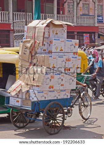 DELHI, INDIA - MARCH 28, 2014: A large load of Phillips food blenders being transported through the Chandni Chowk bazaar in the old part of Delhi