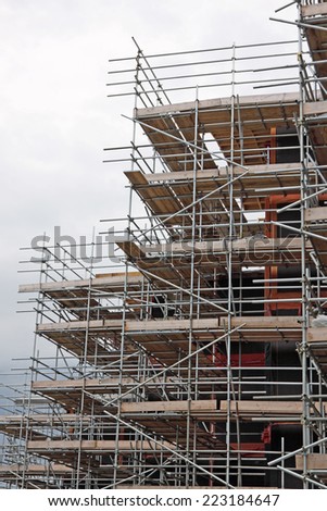 Extensive scaffolding providing platforms for work in progress on a new apartment block UK
