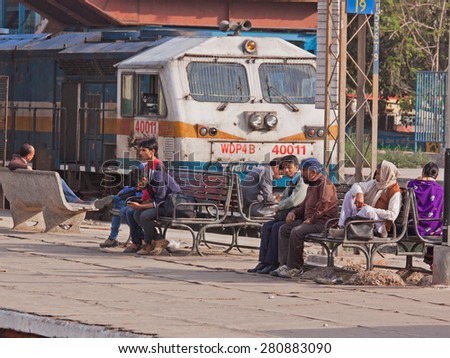 DELHI, INDIA - FEBRUARY 26, 2015: Passengers waiting for commuter trains bound for New Delhi at Shivaji Bridge station.  Many of the 25 million people living in Greater Delhi commute from the suburbs