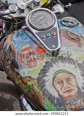 BIDEFORD, ENGLAND - MAY 30, 2015: The decorated fuel tank of a motorcycle at the town\'s Bike Show held annually to support local charities and attracting some 2,000 bikes, many similarly decorated
