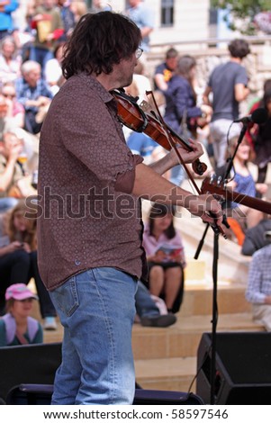 BRISTOL, ENGLAND - JULY 31: Electric violin player at the Harbour Festival in Bristol, England on July 31, 2010. The free three day event played host to more than 250,000 spectators