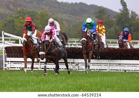 CASTERA VERDUZAN, FRANCE - OCTOBER 4: Nashaassart ridden by J.Viard jumps a fence at the front of a race at the Baron hippodrome Castera Verduzan, France on October 4, 2010.