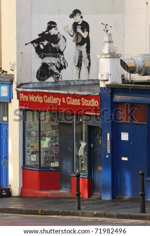 BRISTOL, ENGLAND - FEBRUARY 26: Graffiti by Banksy in Maudlin Street in  Bristol, England on February 26, 2011. Banksy is a native of the city, in which there are many examples of his street art