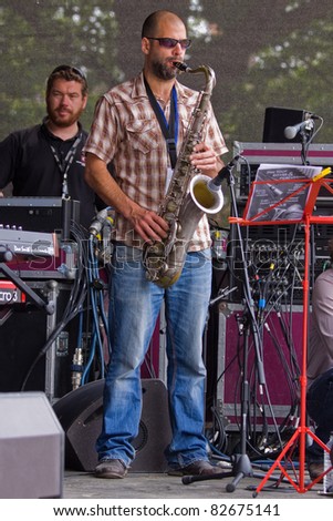 BRISTOL, ENGLAND - JULY 31: Saxophonist in the Pete Josef band on the Queen Square stage at the Harbour Festival in Bristol, England on July 31, 2011. The three day event attracted 280,000 spectators