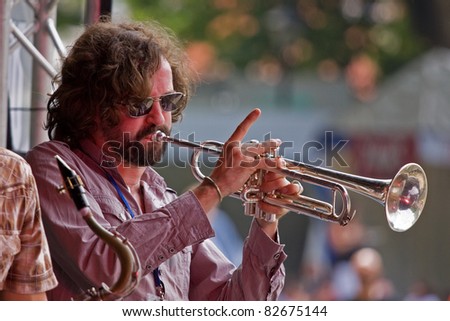 BRISTOL, ENGLAND - JULY 31: Trumpet player in the Pete Josef band on the Queen Square stage at the Harbour Festival in Bristol, England on July 31, 2011. The three day event attracted 280,000 people