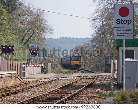 EGGESFORD, ENGLAND - MARCH 24:  Passenger train on the approach to Eggesford station in England on March 24, 2012. The line runs through the heart of Devon linking Exeter with Barnstaple