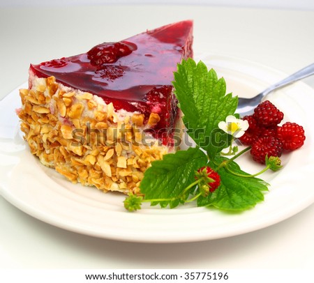 Raspberry cake with raspberries and leaves isolated on white