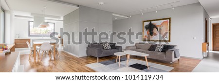 Modern apartment with open living room, kitchenette and dining area, panorama