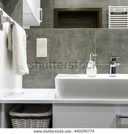 Well organized modern bathroom with white towels