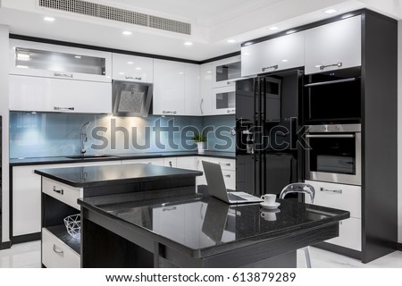 Black and white, stylish, high gloss kitchen with island