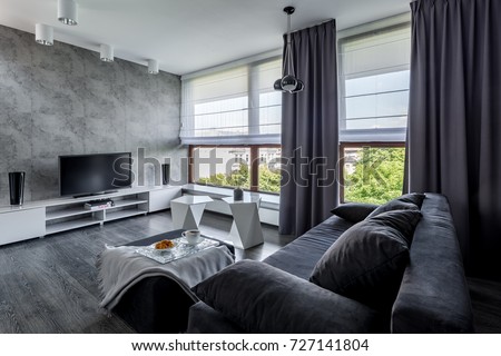 Modern tv living room with couch, new design coffee table and big windows