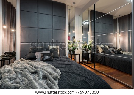Luxurious bedroom with double bed and mirrored wardrobe