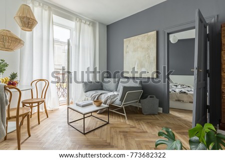 Living room, dining space and bedroom in scandinavian styled flat