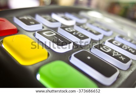 The terminal for cashless payment money bank credit card with glowing buttons and bright multicolored cancel buttons