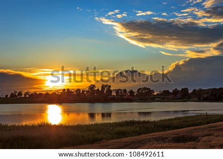 Lake Landscape with sunset reflections on the surface of water.