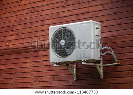 Air conditioner on the wall of boards.