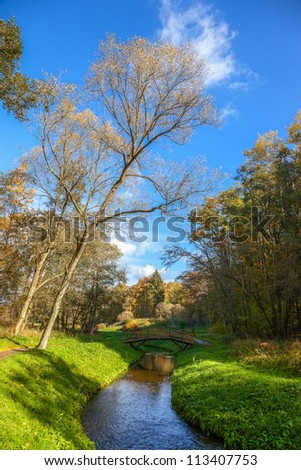 Autumn wood bridge over creek in Polczyn Zdroj, Poland.