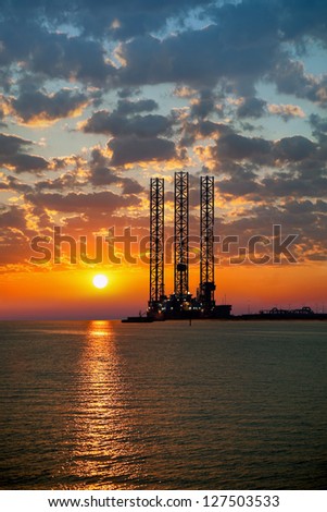 Sea Oil Rig On Sunrise.