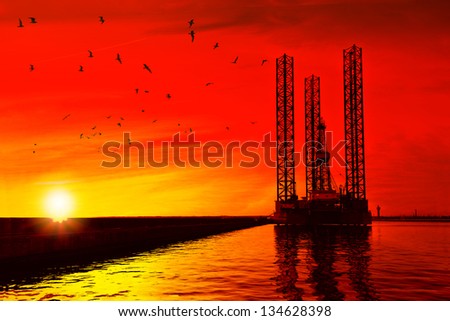 Oil drilling rig in sunset time.