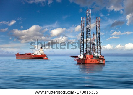 Oil rig and tanker ship on offshore area.