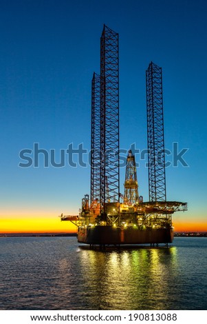 Oil drilling rig in sunset time.