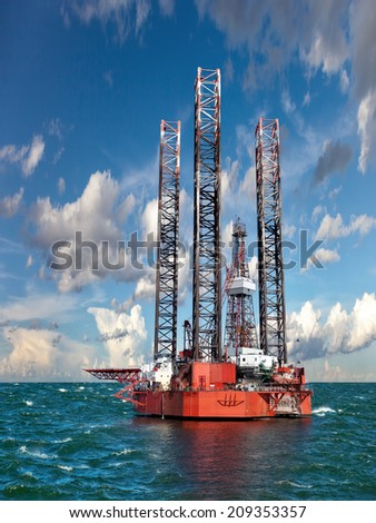 Oil rig at sea against the amazing blue sky.