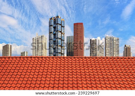 Old roof on the background of a modern skyscrapers.
