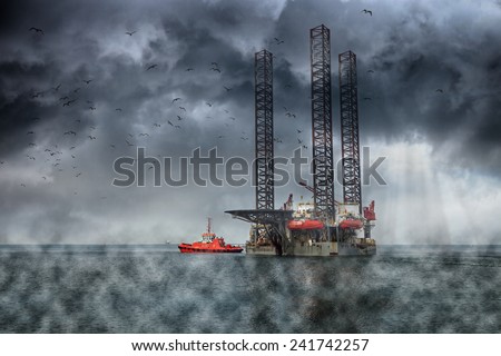 Oil Rig at sea on a dark cloudy dramatic sky.
