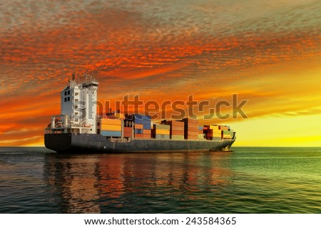 Container ship at sunset in the sea.