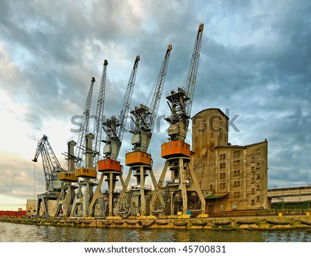 Five Samurai and greybeard with a cane. Port cranes in anticipation of the ship, Gdansk - Poland.