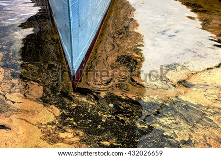 Oil spill from the ship - Texture of crude oil spill on the water.