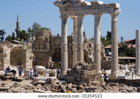 Ruins of Temple of Apollo in Side Turkey with resting tourists