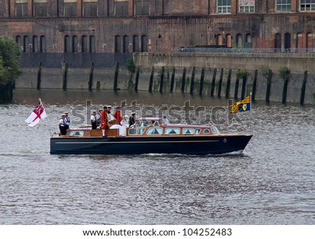 LONDON - JUNE 3: Queen Elizabeth II and Prince Philip as they journey on a motor launch at the start of the Diamond Jubilee Royal Pageant on the River Thames on June 3, 2012 in London