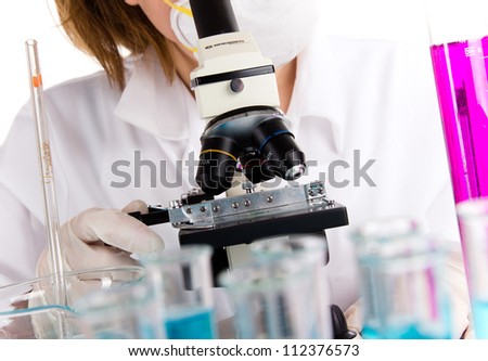 Detail of modern microscope with female researcher in a lab